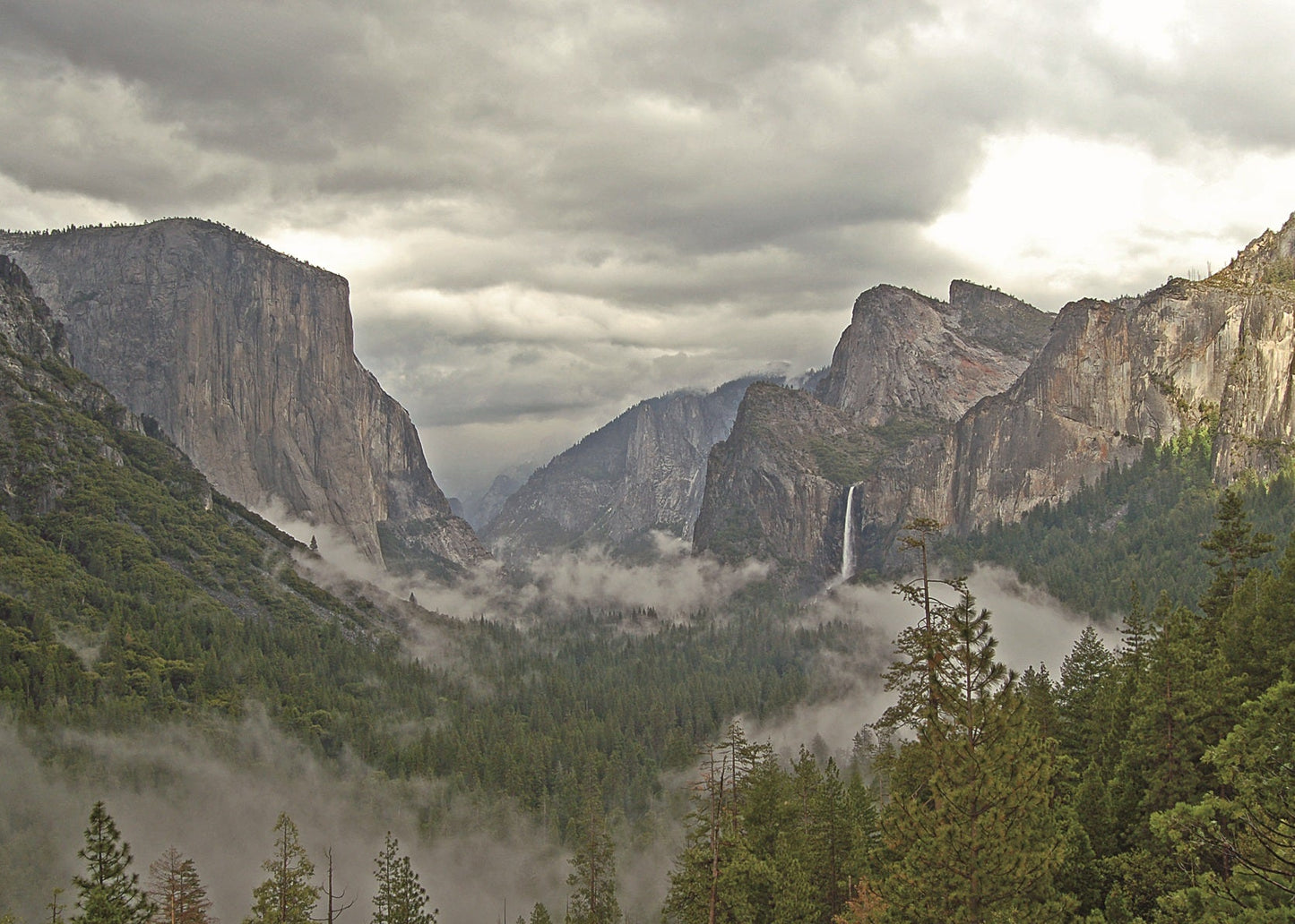 Yosemite Valley, east from the tunnel overlook on its south side. Vertical fractures in the granite account for the high cliffs and the straightness of the valley.