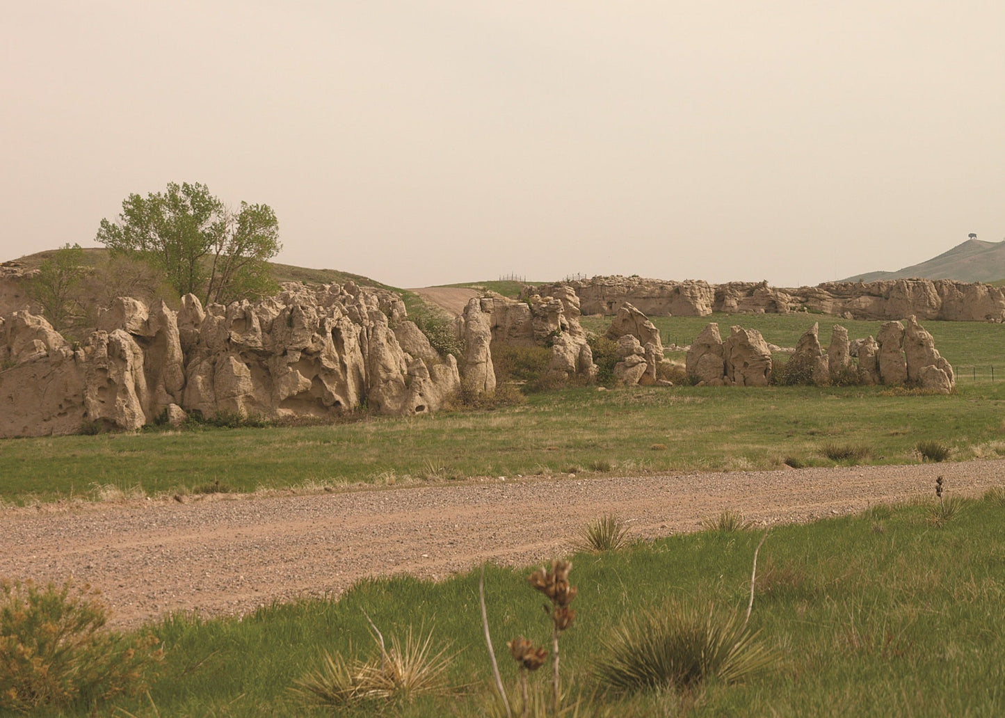 Scenic view of rocky outcrops and a dirt road in a high plains landscape