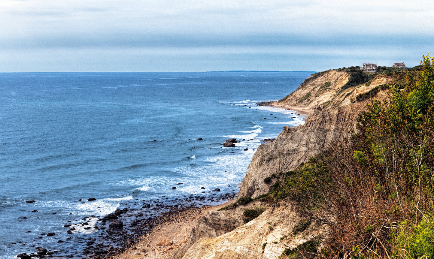 View of blue water from high, brush-covered coastline. Shifting Sand image.