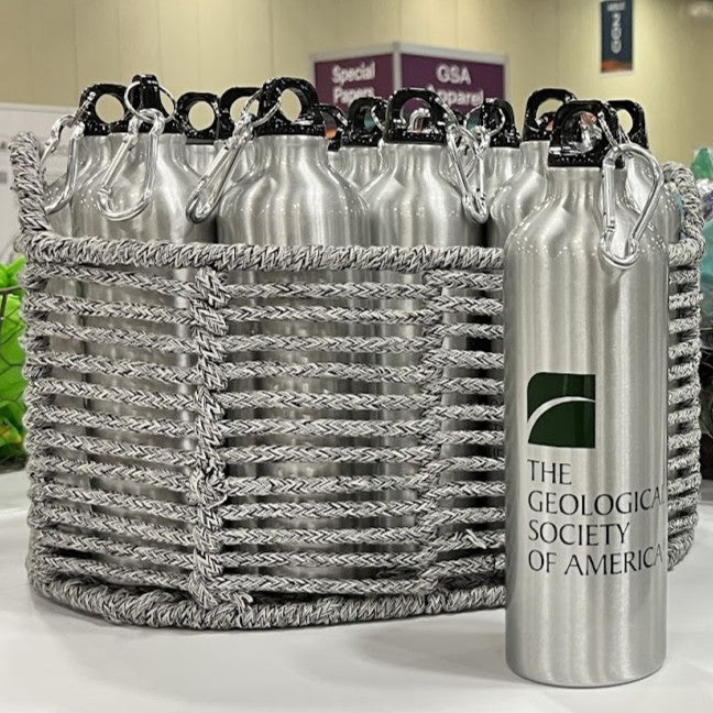 Silver water bottles with 'The Geological Society of America' logo in a woven basket.