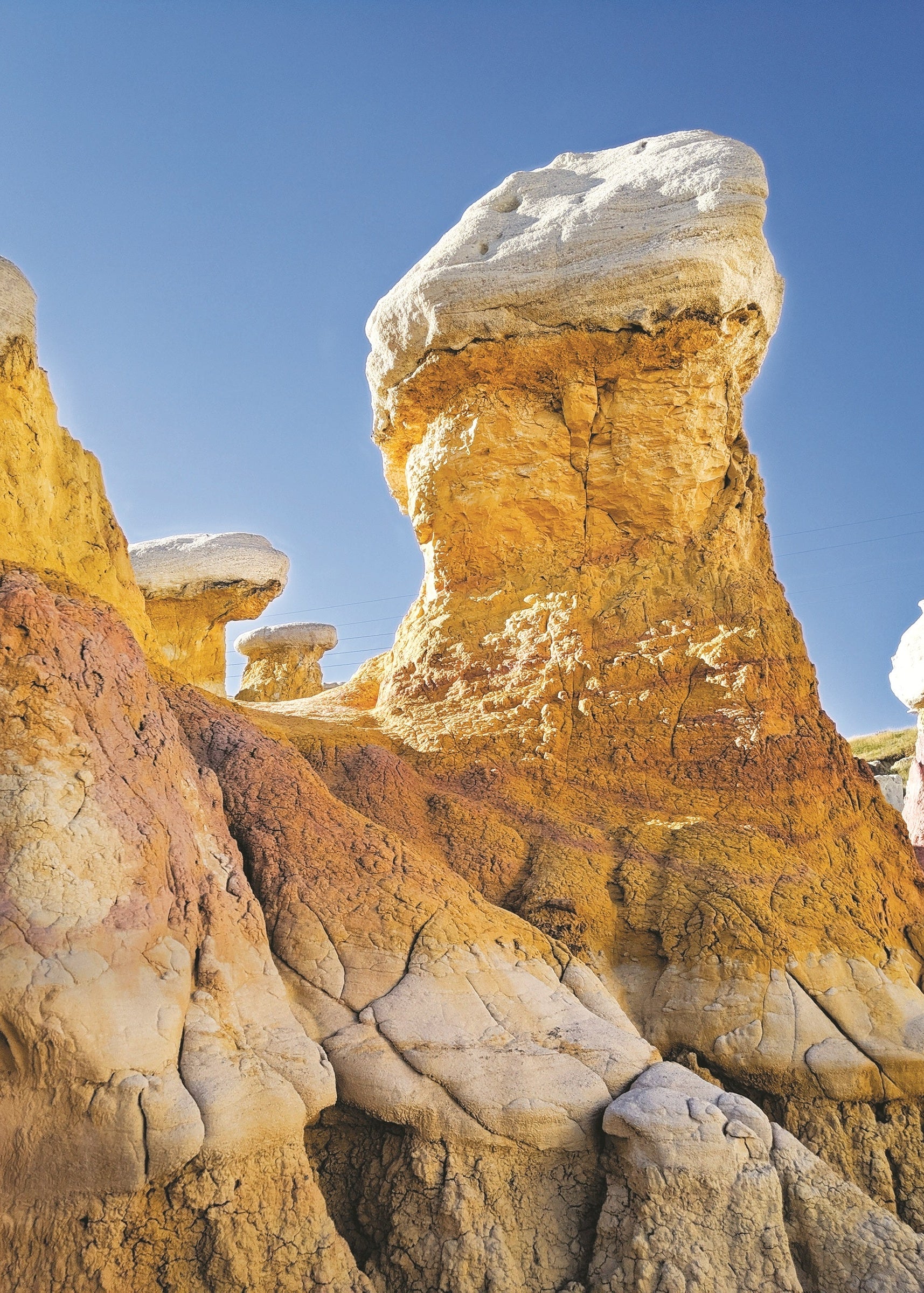 paint mines hoodoo against a blue sky, colorado
