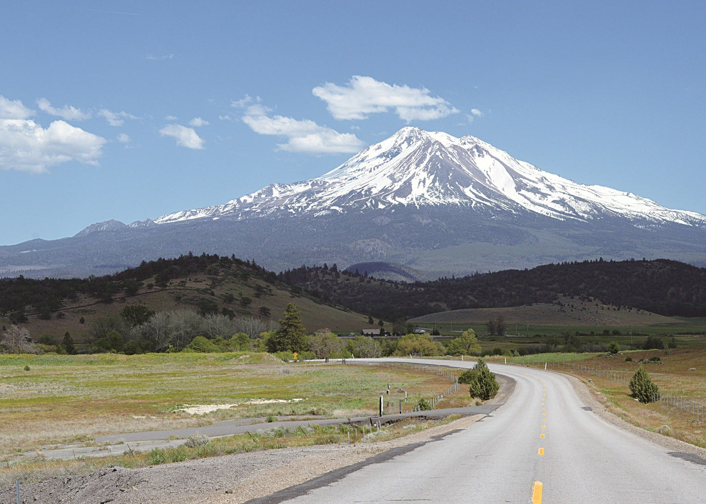 Lumpy hills of debris avalanche in foreground with Mt. Shasta in distance to southeast, viewed from Interstate 5 about 7 miles north of Weed.