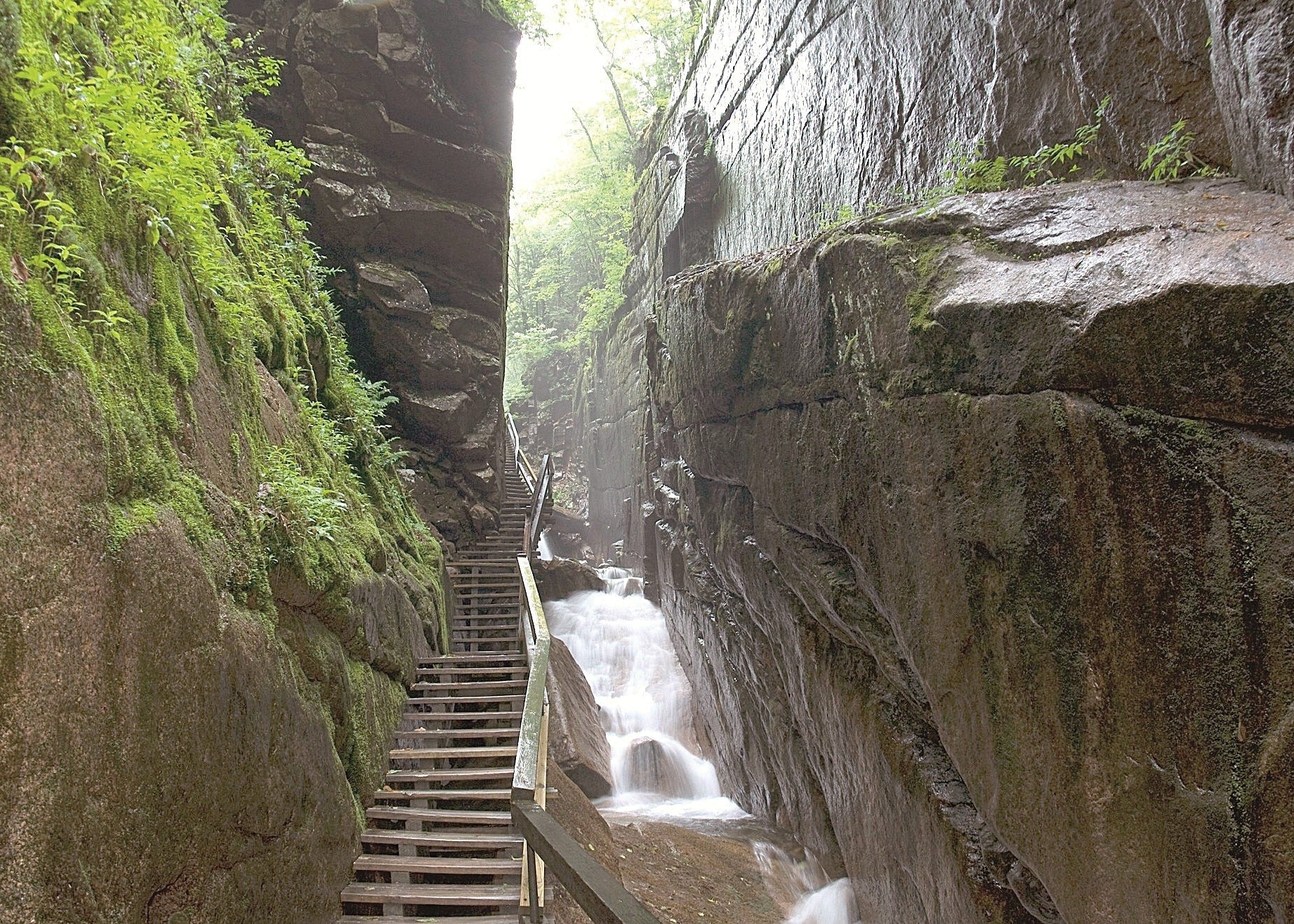 Winding staircase leading through a rocky gorge with waterfalls, Flume Gorge New Hampshire