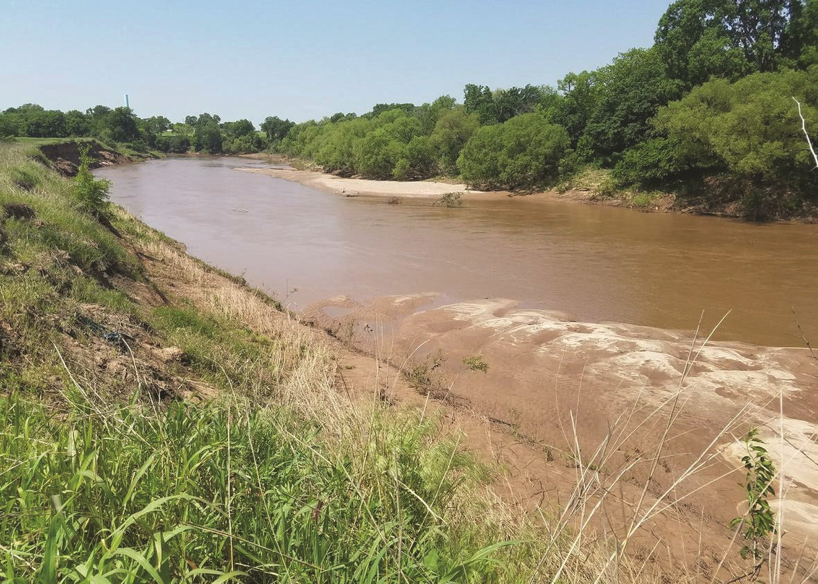 Chikaskia River with green trees and blue sky, Oklahoma