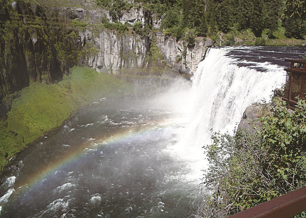 Waterfall with a rainbow at upper mesa falls on the henrys fork in idaho