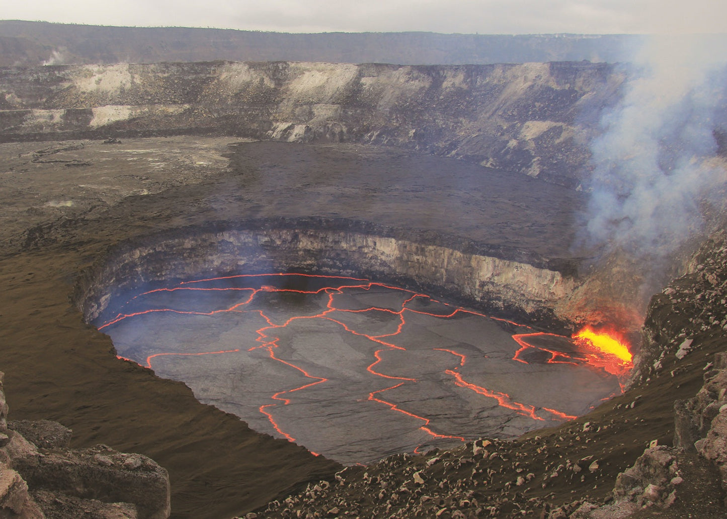 Volcanic crater with glowing lava and smoke, Hawaii