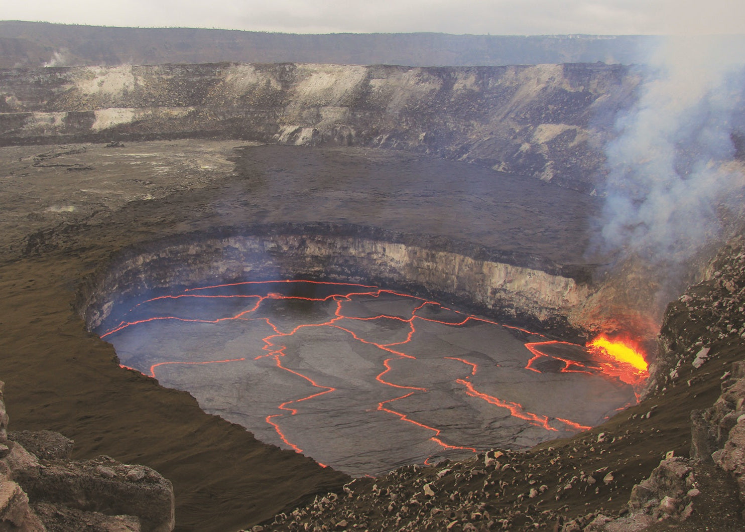 Volcanic crater with glowing lava and smoke, Hawaii