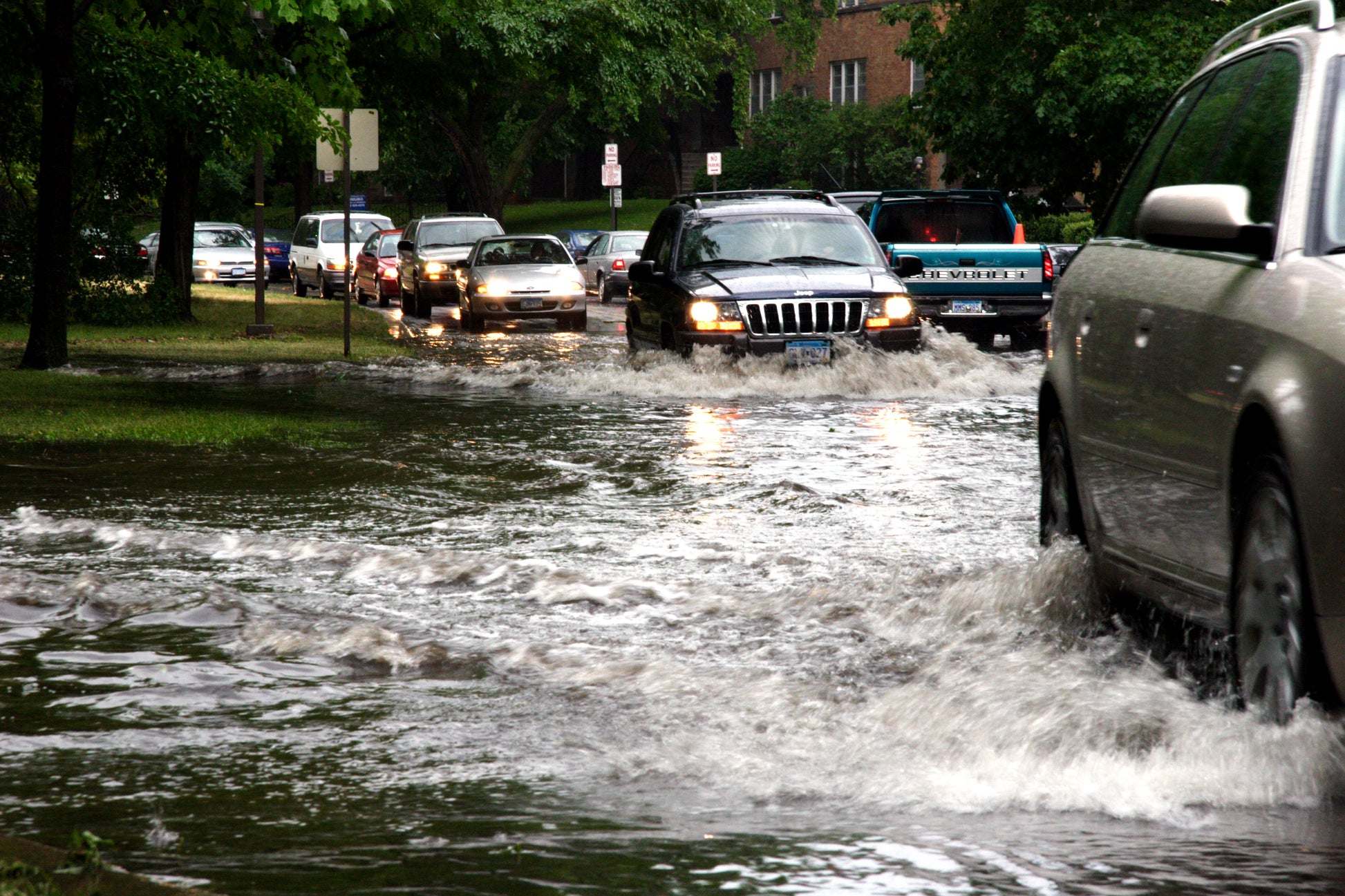 Cars driving through flooded streets. Flood Analysis image.