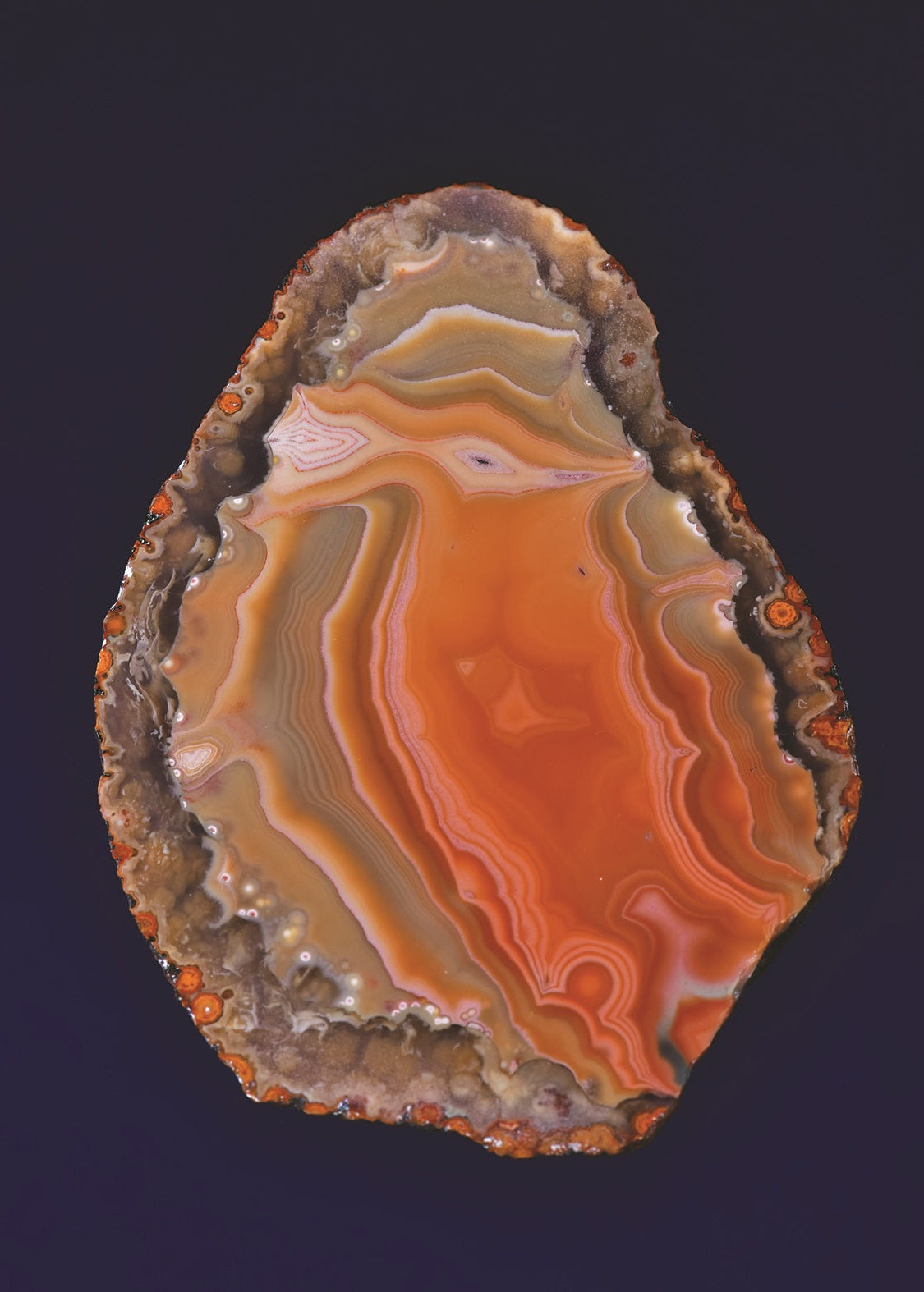 Close-up of a multicolored agate stone on a dark background