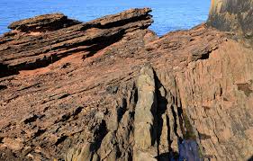 Rugged rocky landscape with a body of water in the background